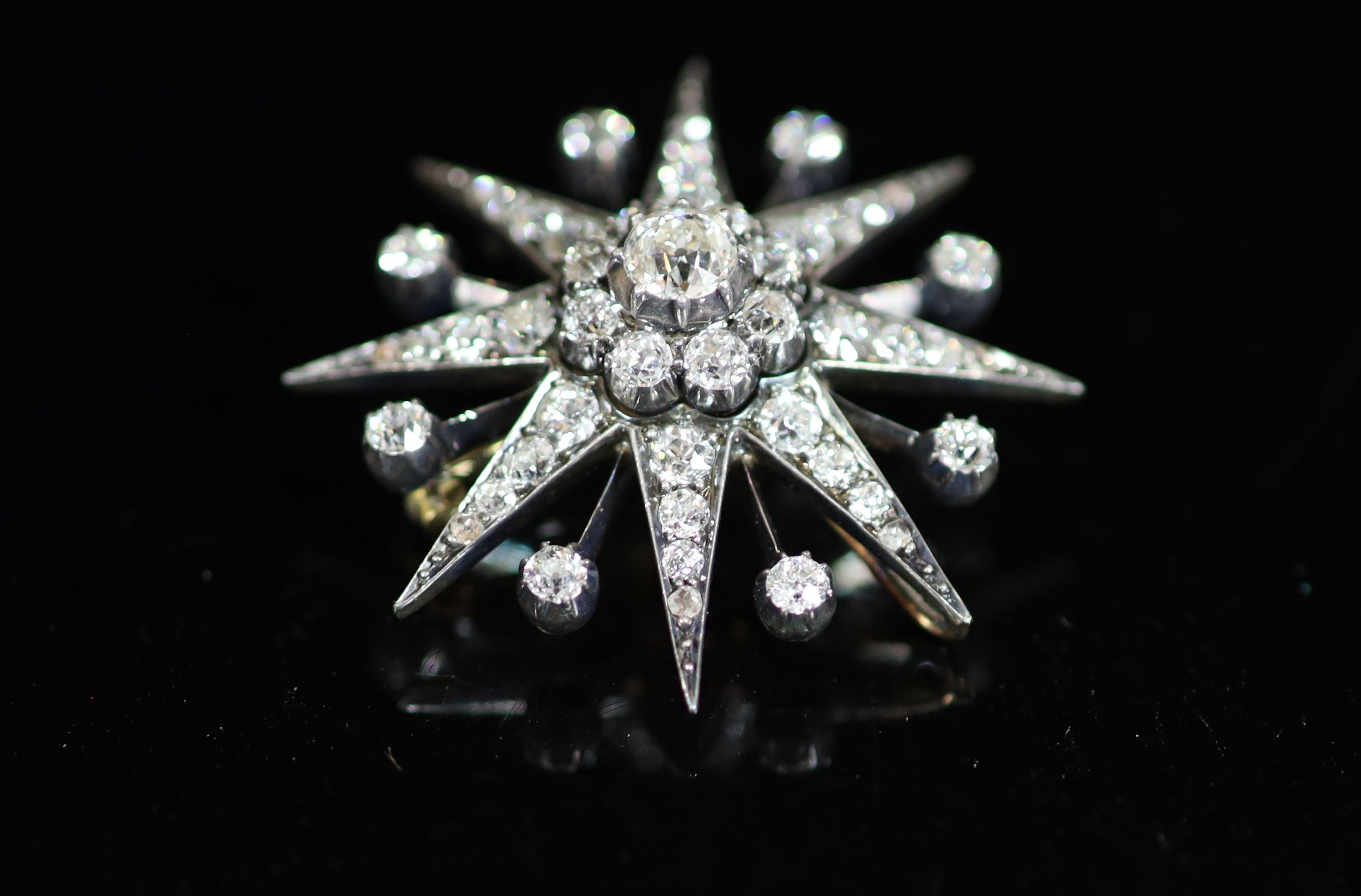 A Victorian gold, silver and diamond set starburst pendant brooch